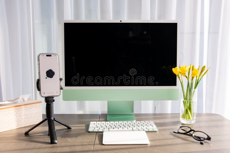 Prague, Czech republic - February 24, 2025: Work place with iMac and iPhone with open Chat Gpt application on screen. Work assistant with Open Ai. Artificial Intelligence concept. High quality photo