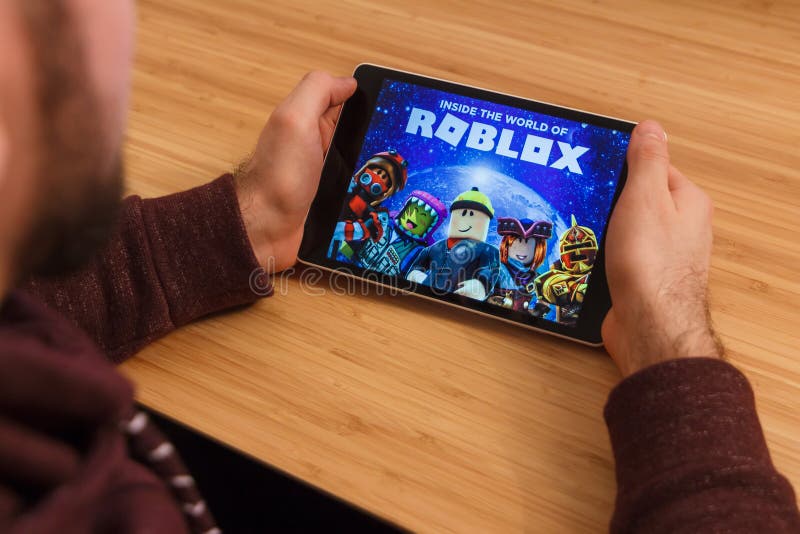 Roblox is an online game platform and game creation system. A smartphone  with the Roblox logo on the screen on the pile of the gamepads Stock Photo  - Alamy