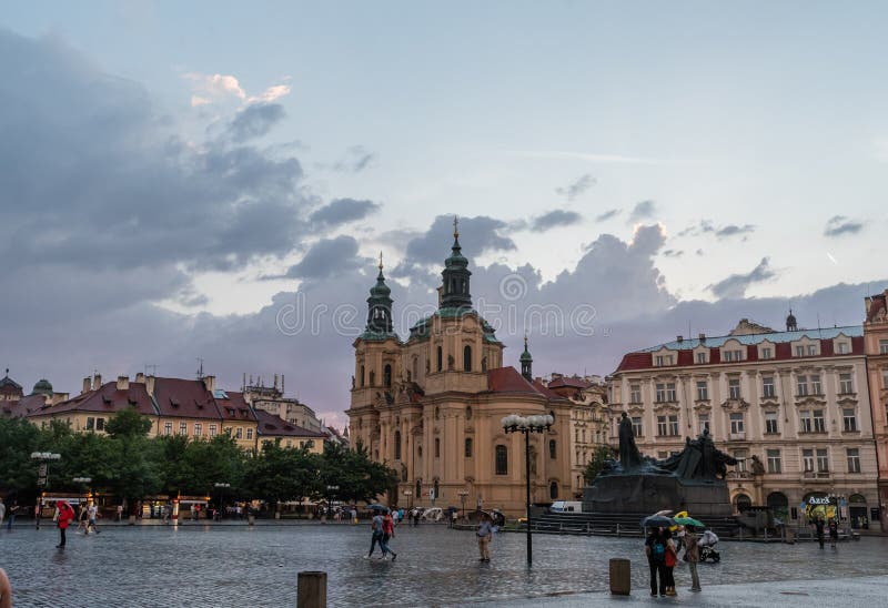 Prague`s Old Town Square and St. Nicholas church at sunset after the rain