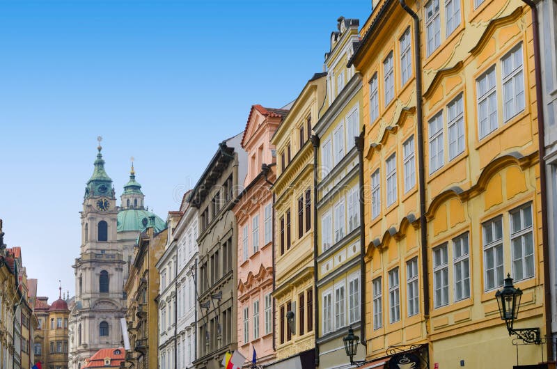 Prague street with colorful houses and church