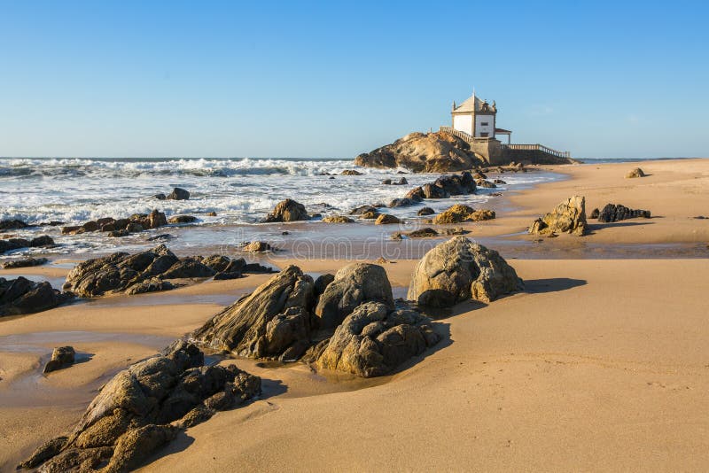 Praia de Miramar Miramar Beach – and the small chapel called Senhor da Pedra stock image Praia de Miramar Miramar Beach – and the small chapel called Senhor da Pedra stock image