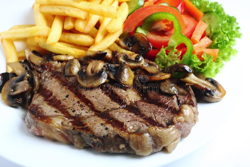 Pranzo cotto della bistecca del ribeye fotografie stock Pranzo cotto della bistecca del ribeye fotografie stock
