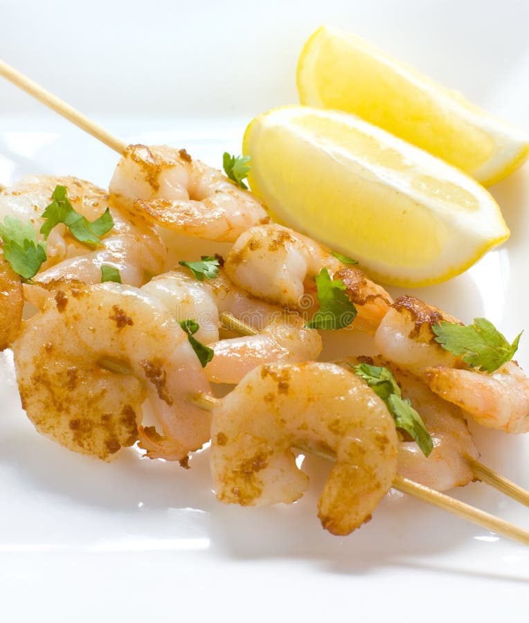 Prawn Skewers with Lemon Wedges stock photography