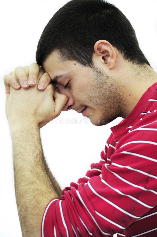 Young man praying, isolated on white