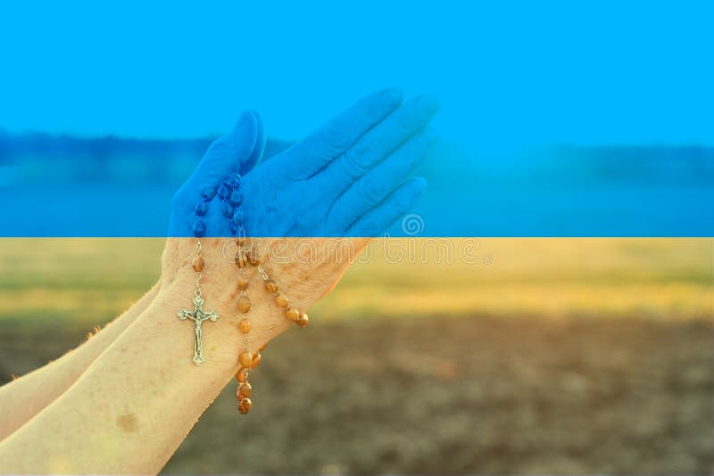 pray for ukraine war concept with flag overlay