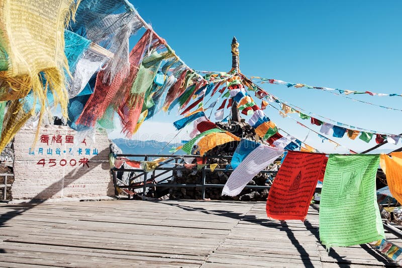 Prayer flags and stupa at the peak of Shika Snow Mountain or Blue Moon Valley in Zhongdian city Shangri-La. Yunnan, China. Asia