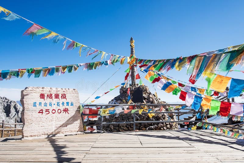 Prayer flags and stupa at the peak of Shika Snow Mountain or Blue Moon Valley in Zhongdian city Shangri-La. Yunnan, China. Asia