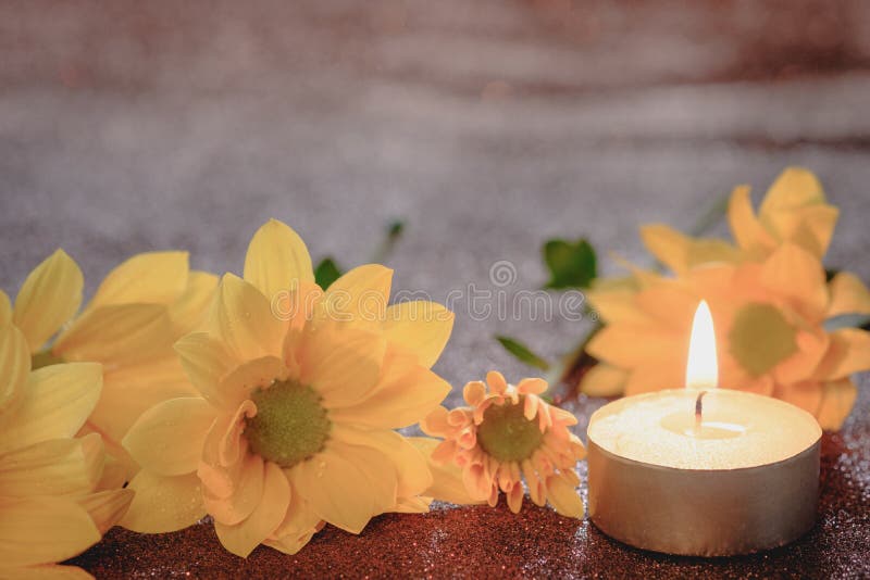 Prayer and hope concept. Retro candle light and yellow flower with lighting effect and glitter abstract background with bokeh defo royalty free stock images Prayer and hope concept. Retro candle light and yellow flower with lighting effect and glitter abstract background with bokeh defo royalty free stock images