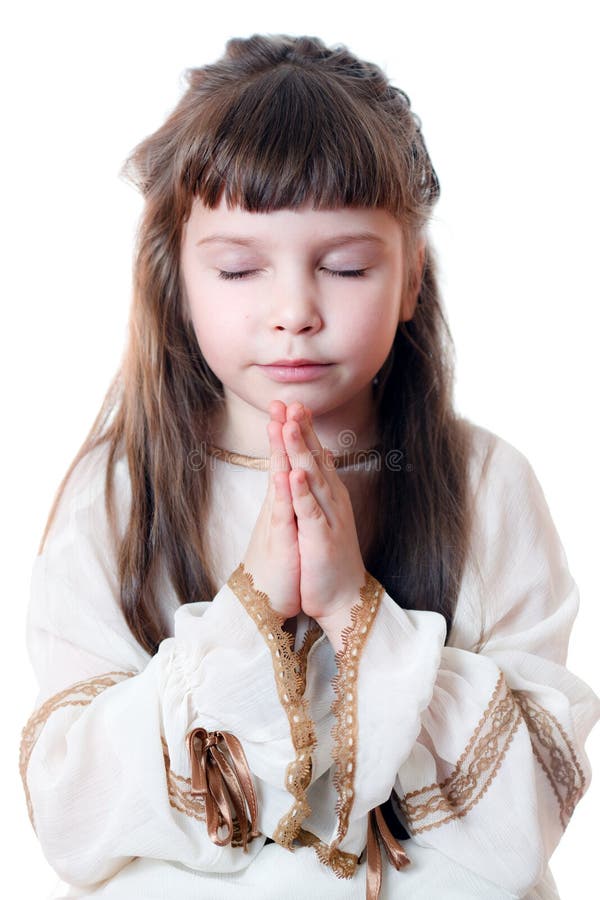 Little girl praying. Isolated on the white. Little girl praying. Isolated on the white