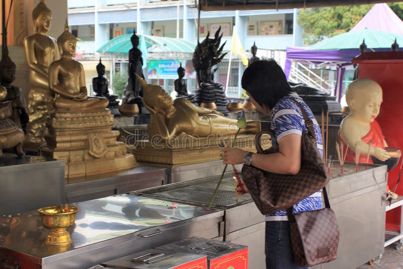 Praying at a chineese buddhist temple of Golden Budda, Wat Traimit