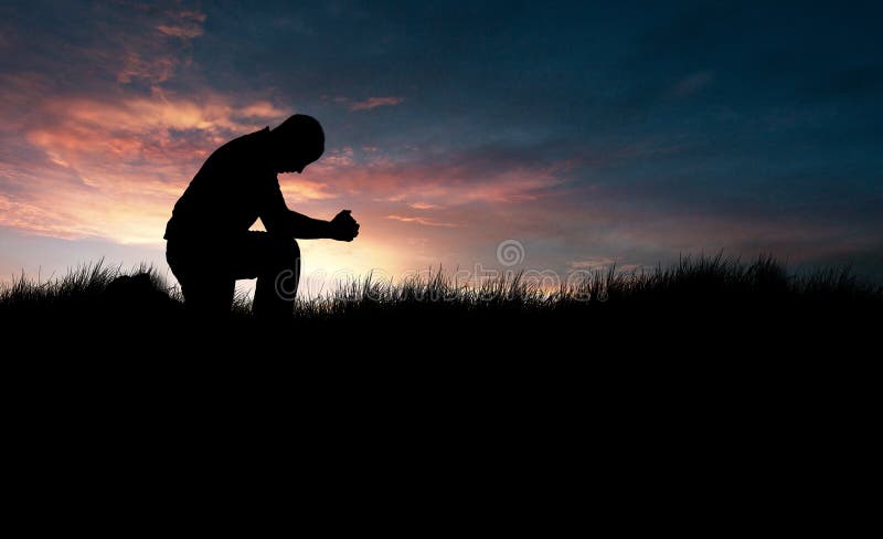 Man praying in the grassy field. Man praying in the grassy field