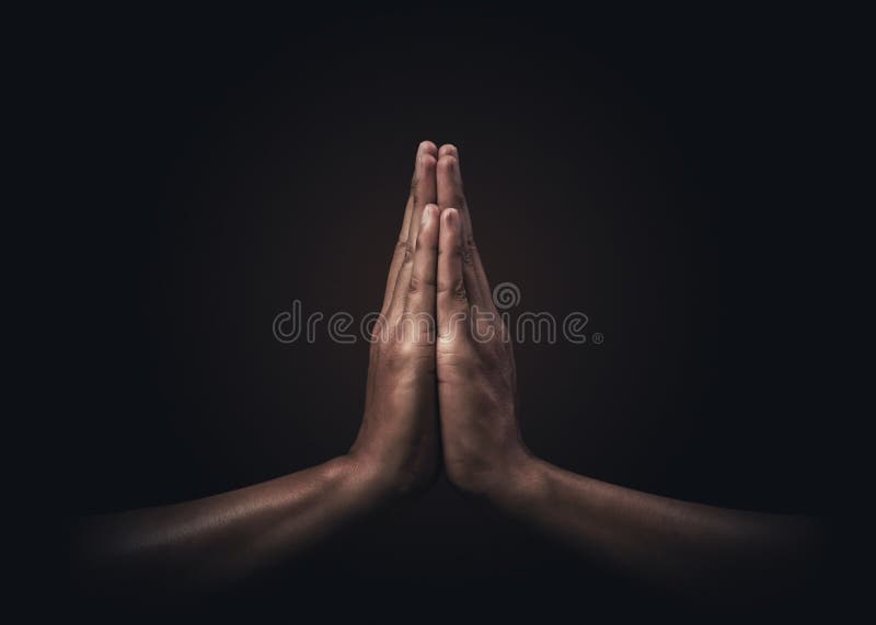 Praying hands with faith in religion and belief in God on dark background. Power of hope or love and devotion. Namaste or Namaskar