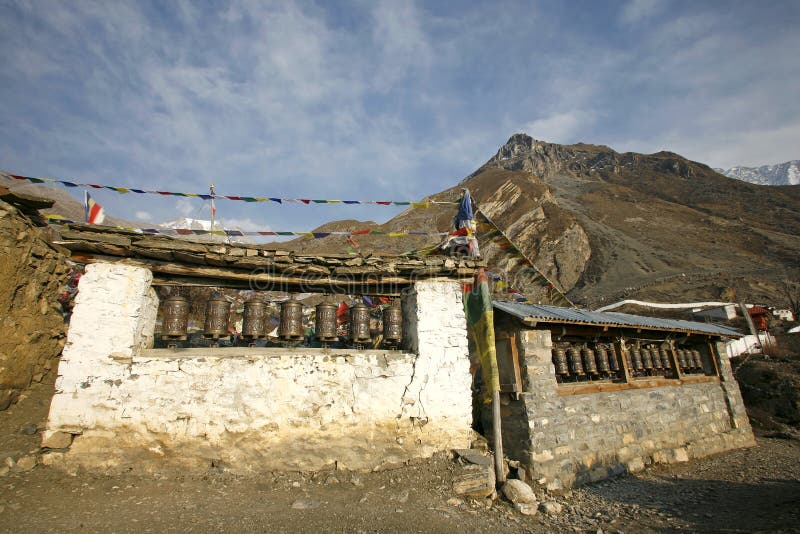 Praying wheels and flags in muktinath stock image