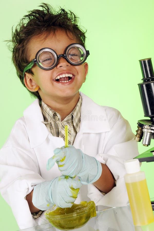 An adorable preschooler with wild hair and coke-bottle glasses delightedly stirring a bowl filled with yucky green slime. An adorable preschooler with wild hair and coke-bottle glasses delightedly stirring a bowl filled with yucky green slime.