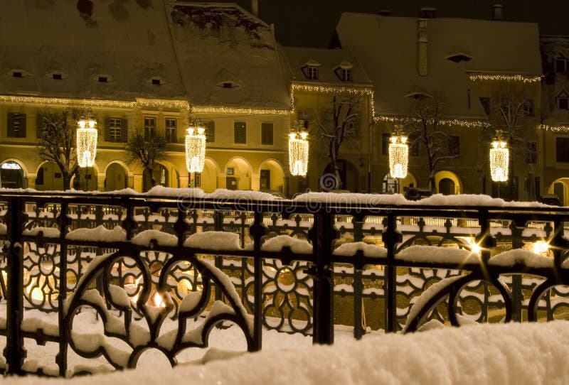 Winter snow town square houses christmas new year decoration public lighting fairy like atmosphere Sibiu Transylvania. Winter snow town square houses christmas new year decoration public lighting fairy like atmosphere Sibiu Transylvania