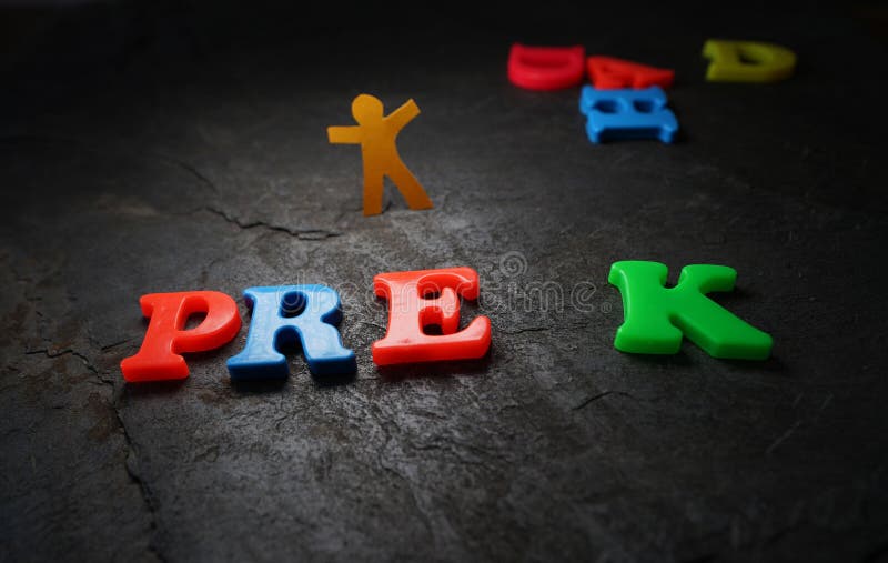 Pre K ( Pre Kindergarten ) play letters with paper cutout child in the background royalty free stock photo