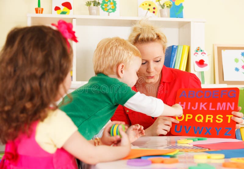 Pre-school children in classroom with teacher