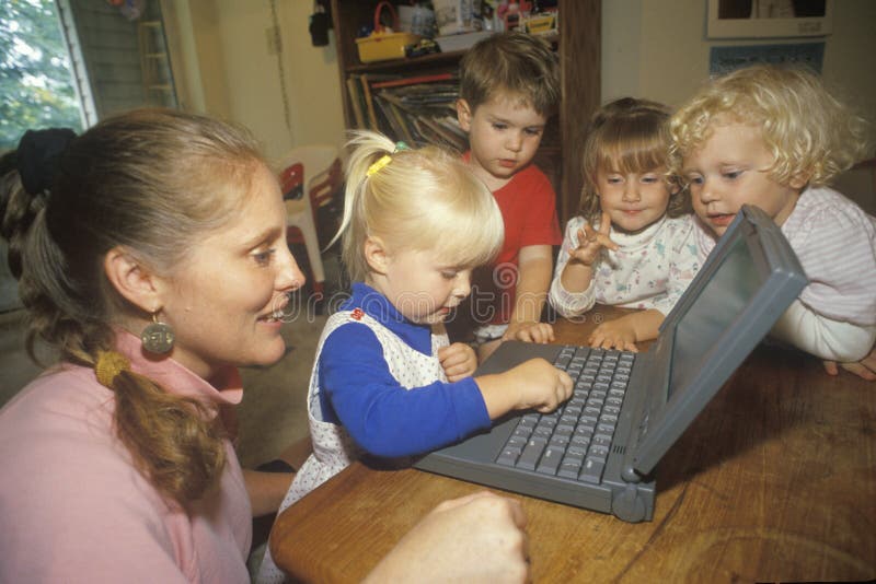 Pre-schoolers exploring a laptop computer royalty free stock image