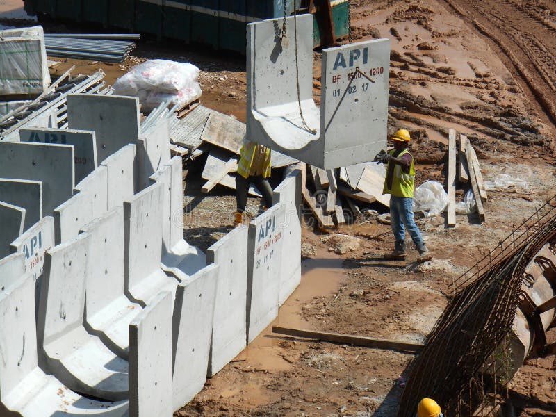 Precast concrete u-shape drain stock stacked at the construction site.