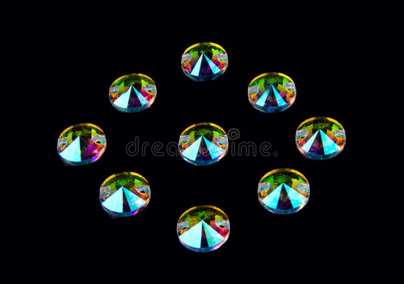Precious stones crystals in the shape of a circle on a black background. stock photography