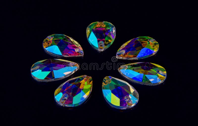 Precious stones crystals in the shape a tear drop on a black acrilic background. royalty free stock photos