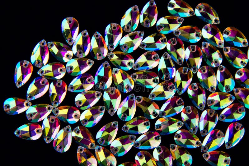 Precious stones crystals in the shape a tear drop on a black background. stock photos