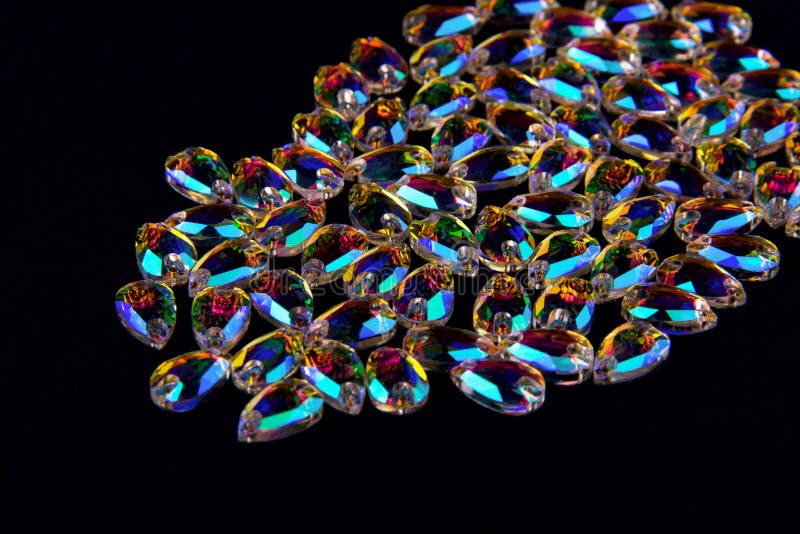 Precious stones crystals in the shape a tear drop on a black background. royalty free stock image