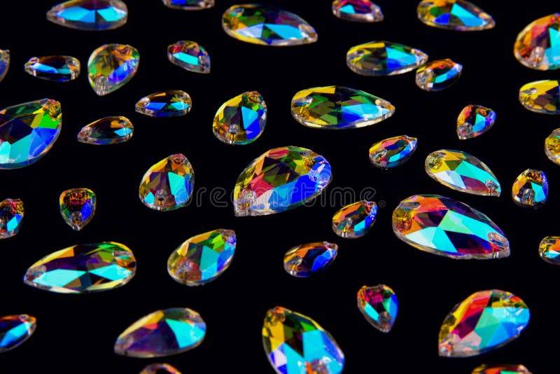 Precious stones crystals in the shape a tear drop on a black background. royalty free stock photo