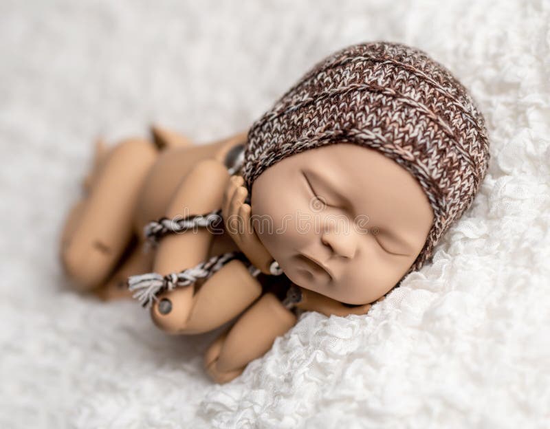 Precisely accurate mannequin of newborn in a hat for photo practicing. Little marionette stock images, royalty-free photos and pictures