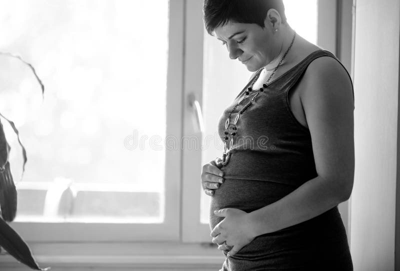 Pregnancy, love, people and expectation concept - happy pregnant stock photo Pregnancy, love, people and expectation concept - happy pregnant stock photo