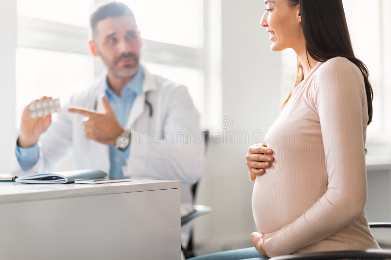 Pregnancy And Medicine Concept Male Gynecologist Giving Pills To Pregnant Lady During 