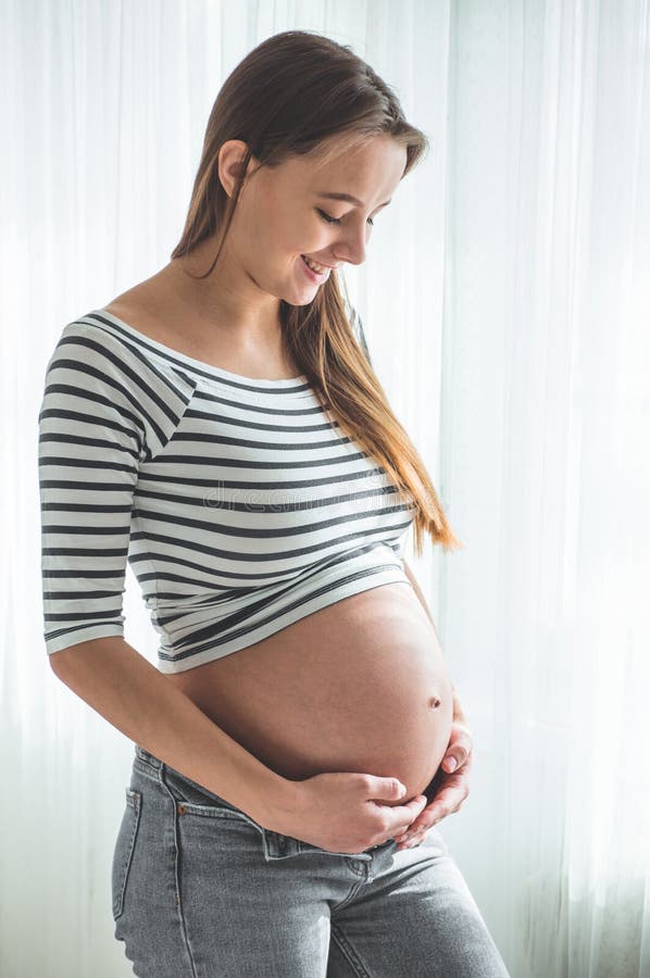 Happy Pregnant Woman with Big Belly by the Window. Concepts of Pregnancy  and Family Stock Image - Image of childbirth, happiness: 170203771