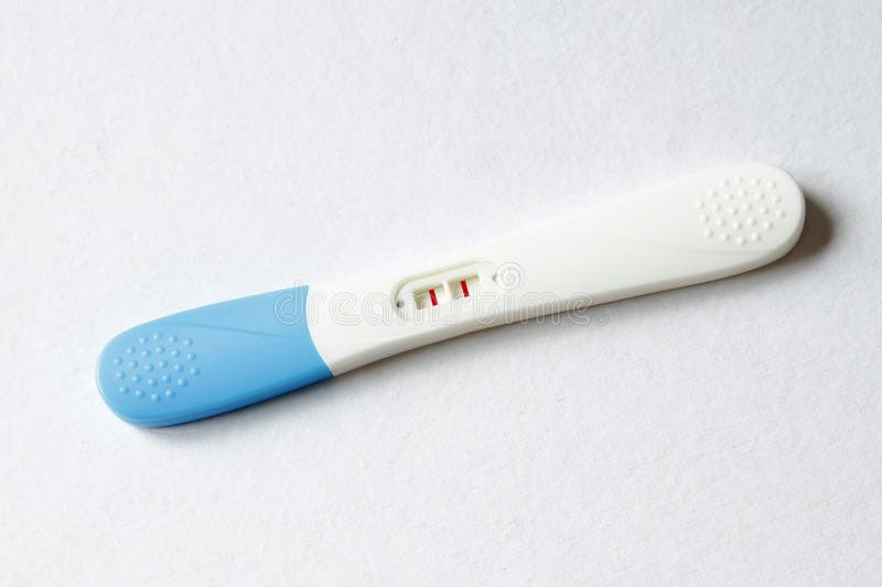 Pregnancy Test Positive Result on Clinic Table Present Red Ribbon Stock