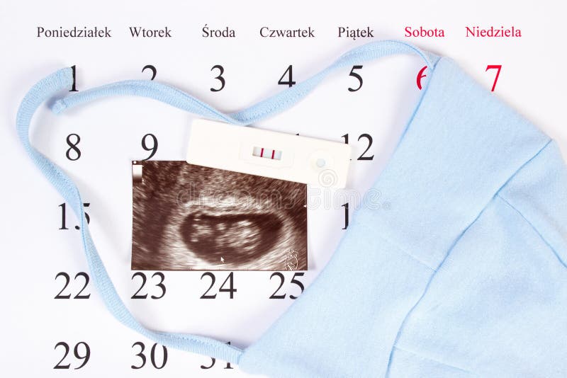 Pregnancy test, ultrasound scan of baby and clothing for newborn on calendar, expecting for baby royalty free stock photo