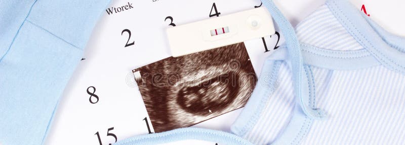 Pregnancy test, ultrasound scan of baby and clothing for newborn on calendar, expecting for baby concept royalty free stock image