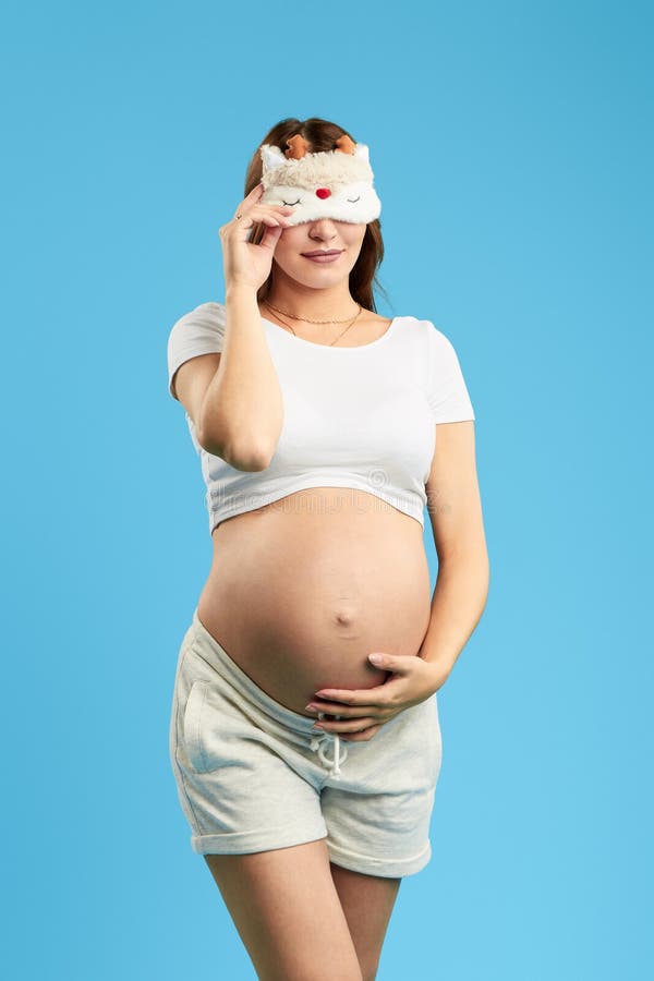 Pregnant attractive woman wearing sleeping mask on eyes stock photography Pregnant attractive woman wearing sleeping mask on eyes stock photography