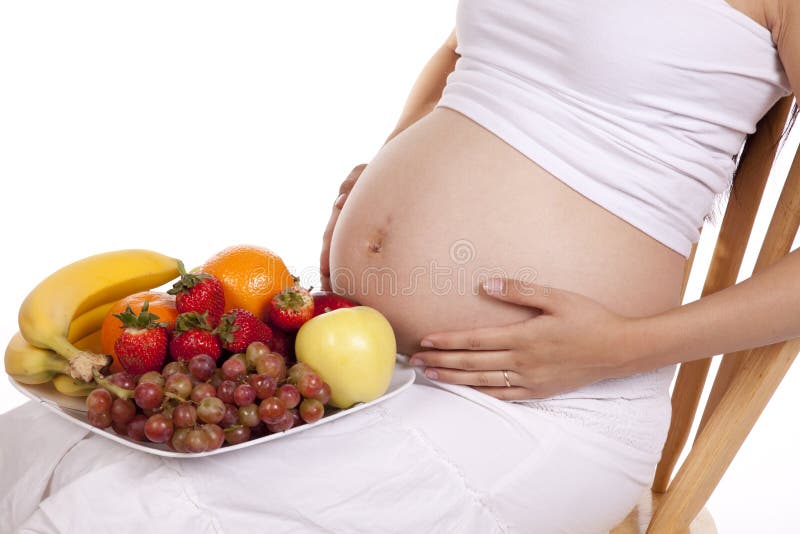 Pregnant belly and fruit