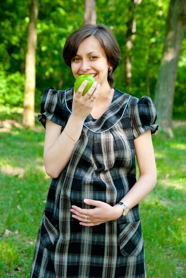 Pregnant eating apple