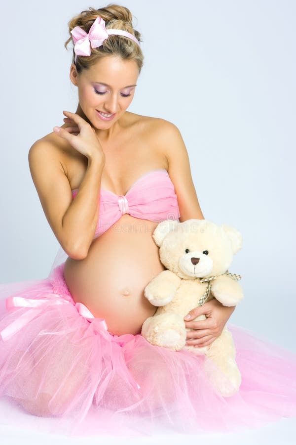 Pregnant girl with teddy bear