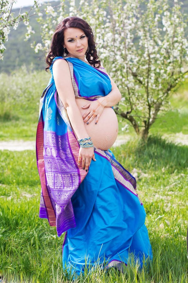 Pregnant Girl Is Wearing Blue Sari On The Nature Stock P