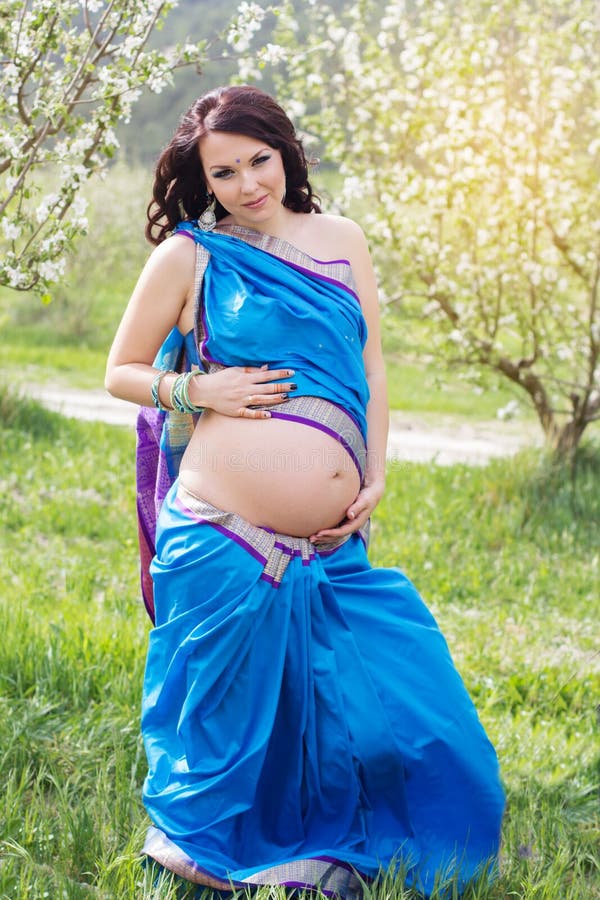 Pretty Pregnant Woman Is Wearing Indian Sari Dress In Blossom Garden Stock  Photo, Picture and Royalty Free Image. Image 55656429.