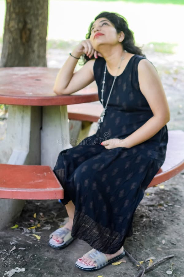 A Pregnant Indian Lady Poses for Outdoor Pregnancy Shoot and Hands