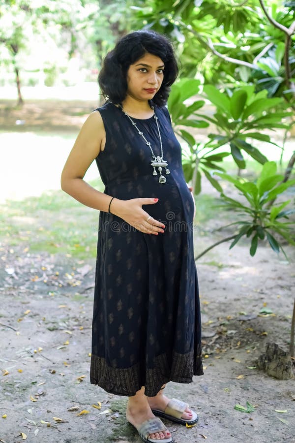 A Pregnant Indian Lady Poses for Pregnancy Shoot and Hands on