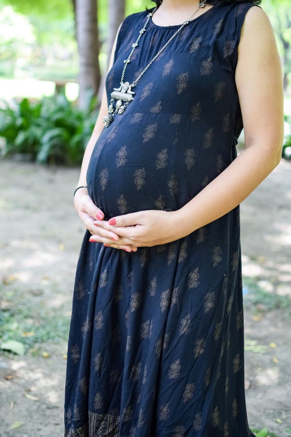 A Pregnant Indian Lady Poses for Pregnancy Shoot and Hands on