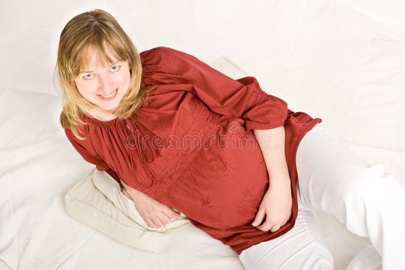 A pregnant lady smiling