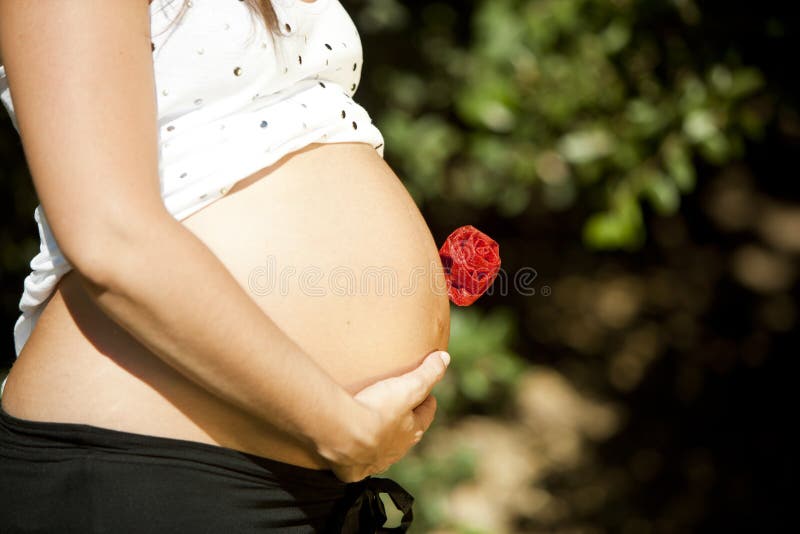 Pregnant mother holding a flower