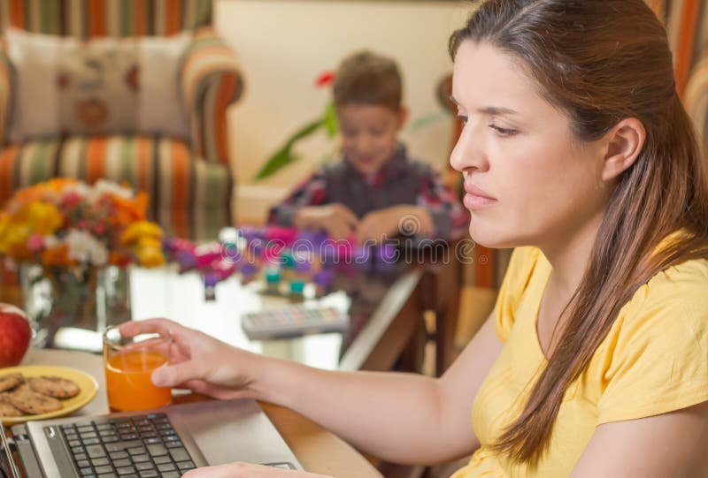 Pregnant mother working in home office with son royalty free stock photos Pregnant mother working in home office with son royalty free stock photos