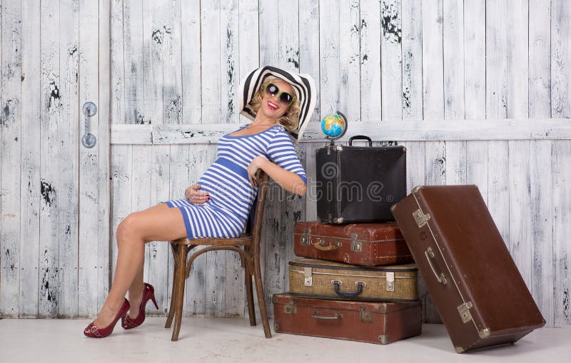 Pregnant tourist with suitcases