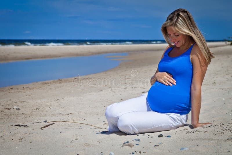 Pregnant woman on beach