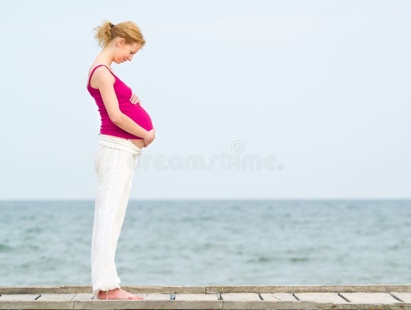 Pregnant woman on beach stock photo Pregnant woman on beach stock photo